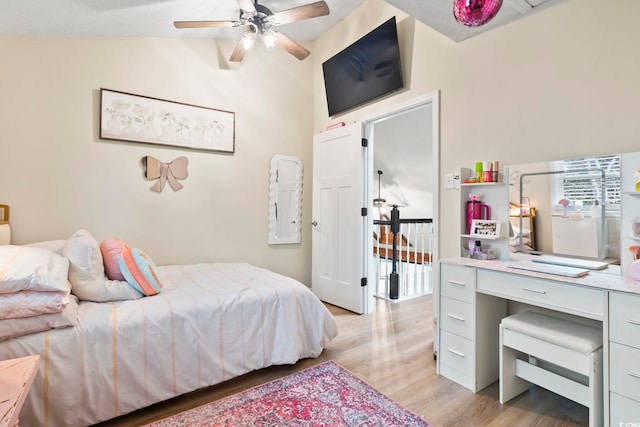 bedroom with light wood-type flooring and vaulted ceiling