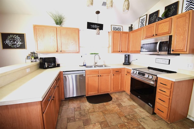 kitchen featuring sink, appliances with stainless steel finishes, and pendant lighting