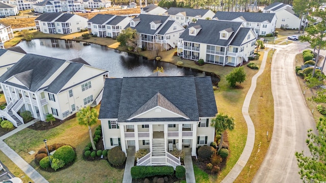 bird's eye view featuring a residential view and a water view