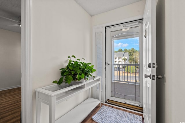 doorway with dark wood-style flooring