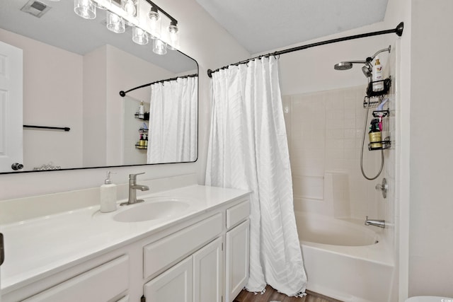 bathroom with vanity, shower / bath combination with curtain, and visible vents