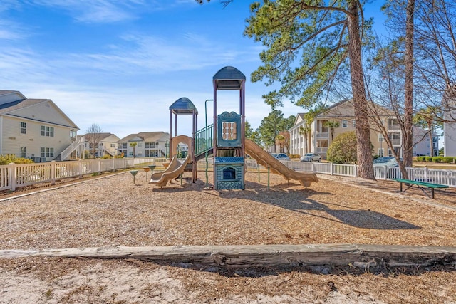 communal playground with a residential view and fence