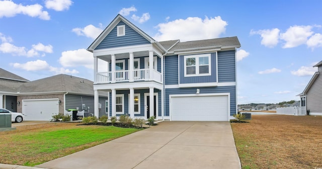 1043 Harbison Cir, Myrtle Beach, SC 29579 - view of front facade with a balcony, a front yard, an attached garage, concrete driveway, and a porch