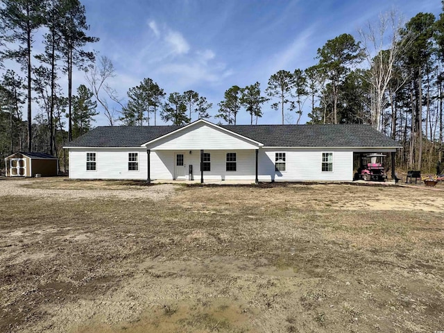 ranch-style home featuring a storage unit, an outdoor structure, and a front yard