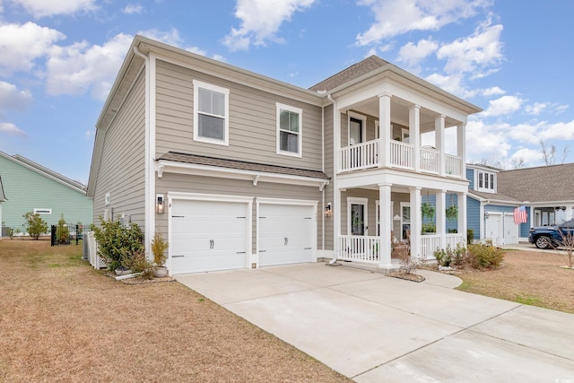 view of front of house featuring driveway, a balcony, an attached garage, a porch, and a front yard