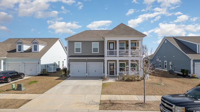 view of front facade with a porch, concrete driveway, a balcony, a garage, and cooling unit