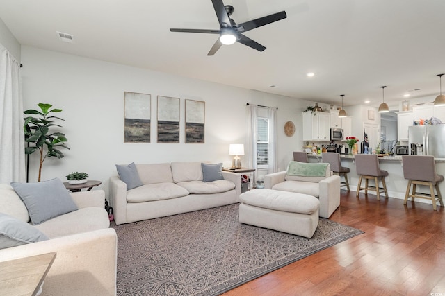 living area with recessed lighting, dark wood-style flooring, visible vents, and ceiling fan