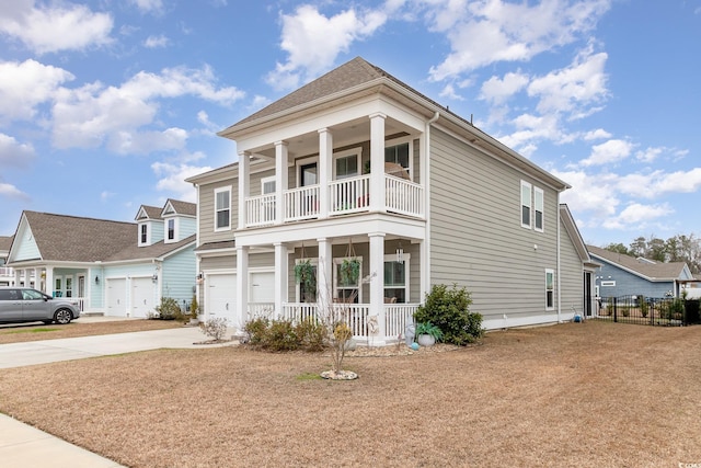 view of front of property featuring a balcony, a garage, a porch, and concrete driveway