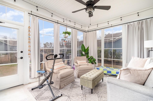 sunroom / solarium with a ceiling fan