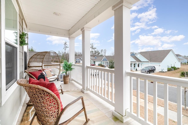 balcony featuring covered porch and a residential view