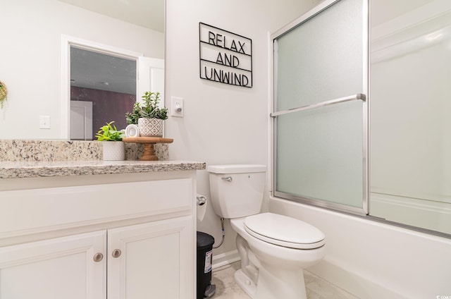 full bathroom with enclosed tub / shower combo, vanity, and toilet