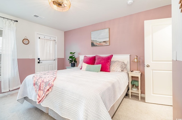 bedroom with light carpet and visible vents