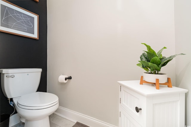 bathroom with toilet, tile patterned flooring, baseboards, and vanity