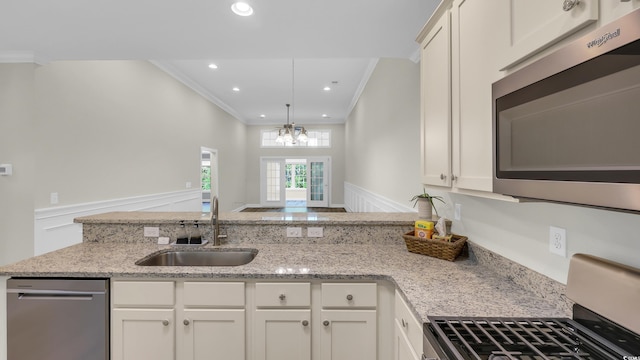 662 Sunnyside Dr Unit 101, Murrells Inlet, SC 29576 - kitchen featuring appliances with stainless steel finishes, crown molding, light stone counters, white cabinetry, and recessed lighting