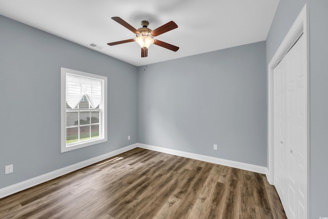 662 Sunnyside Dr Unit 101, Murrells Inlet, SC 29576 - unfurnished bedroom with a closet, dark wood-style flooring, and ceiling fan