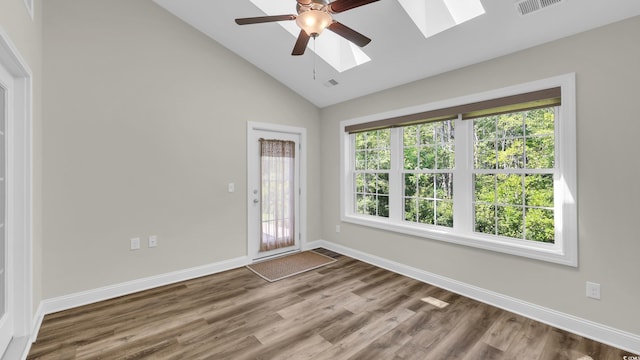662 Sunnyside Dr Unit 101, Murrells Inlet, SC 29576 - unfurnished room with a skylight, healthy amount of natural light, a ceiling fan, wood finished floors, and high vaulted ceiling