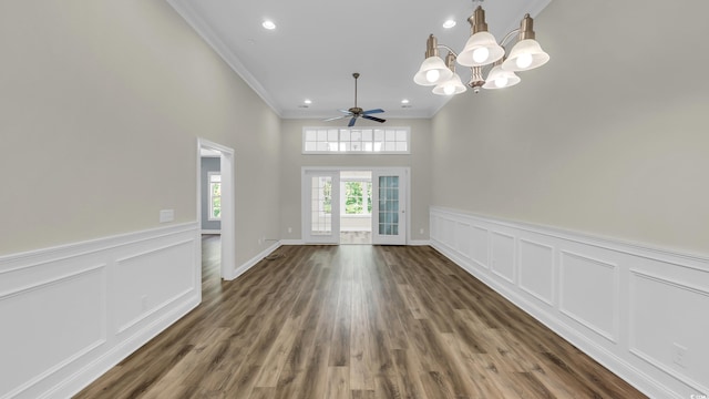 662 Sunnyside Dr Unit 101, Murrells Inlet, SC 29576 - unfurnished dining area featuring crown molding, a chandelier, a decorative wall, wainscoting, and wood finished floors