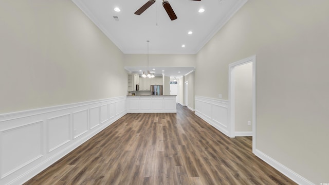 662 Sunnyside Dr Unit 101, Murrells Inlet, SC 29576 - unfurnished living room featuring ornamental molding, ceiling fan, a chandelier, a wainscoted wall, and dark wood-type flooring
