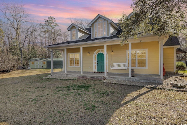 view of front of home with a lawn and covered porch