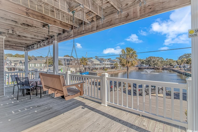 wooden deck featuring a water view and a residential view