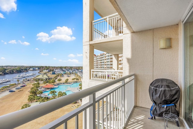 balcony featuring a water view and grilling area