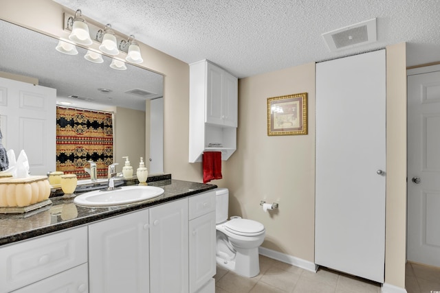 bathroom with visible vents, toilet, tile patterned flooring, a textured ceiling, and vanity