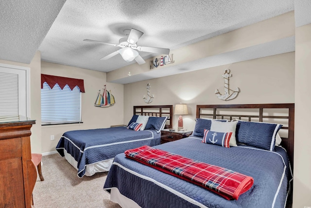 carpeted bedroom featuring a ceiling fan, a textured ceiling, and baseboards