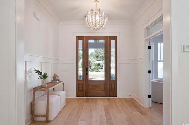 1328 Foxtail Dr, Longs, SC 29568 - foyer entrance with a decorative wall, a chandelier, light wood-style floors, wainscoting, and ornamental molding