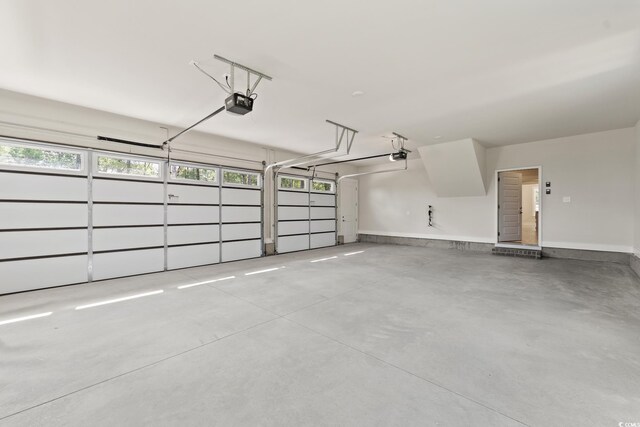 1328 Foxtail Dr, Longs, SC 29568 - garage featuring a garage door opener and baseboards
