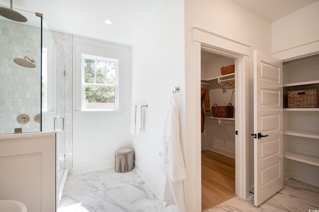 1328 Foxtail Dr, Longs, SC 29568 - full bath featuring marble look tile flooring, a shower stall, recessed lighting, baseboards, and a walk in closet
