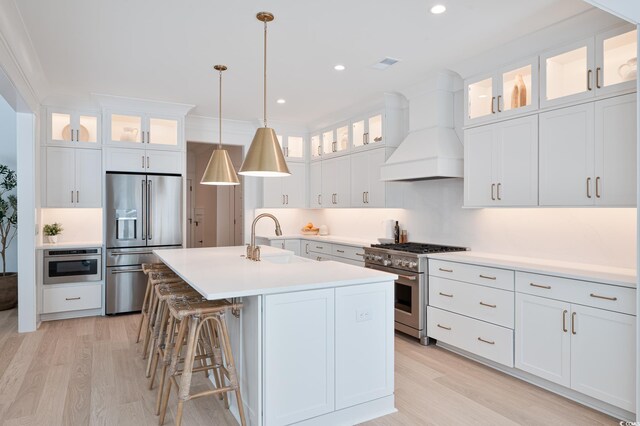 1328 Foxtail Dr, Longs, SC 29568 - kitchen with premium appliances, a sink, custom exhaust hood, light wood finished floors, and recessed lighting