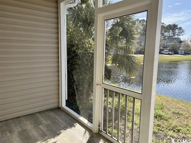 unfurnished sunroom featuring a water view