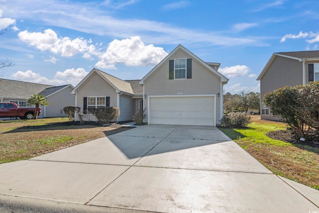 traditional home featuring an attached garage, driveway, and a front yard