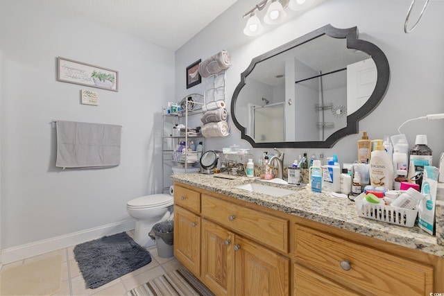 full bathroom with toilet, a stall shower, vanity, tile patterned flooring, and baseboards