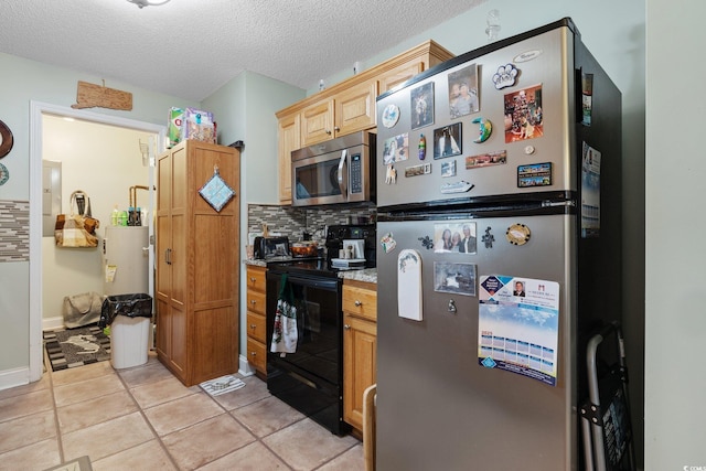 kitchen featuring light tile patterned floors, light countertops, backsplash, appliances with stainless steel finishes, and a textured ceiling