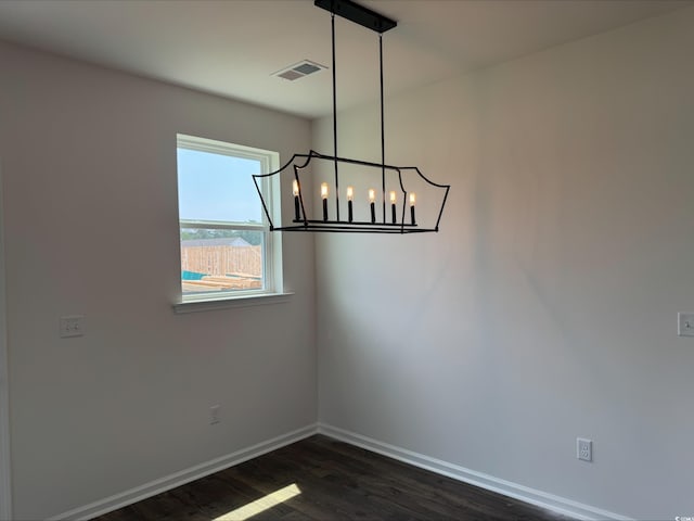 1001 Cavaletti Ct, Myrtle Beach, SC 29588 - spare room featuring dark wood-style floors, baseboards, and a chandelier