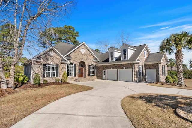 view of front of home with brick siding, driveway, and an attached garage