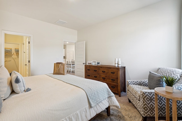 bedroom featuring carpet, a walk in closet, and visible vents