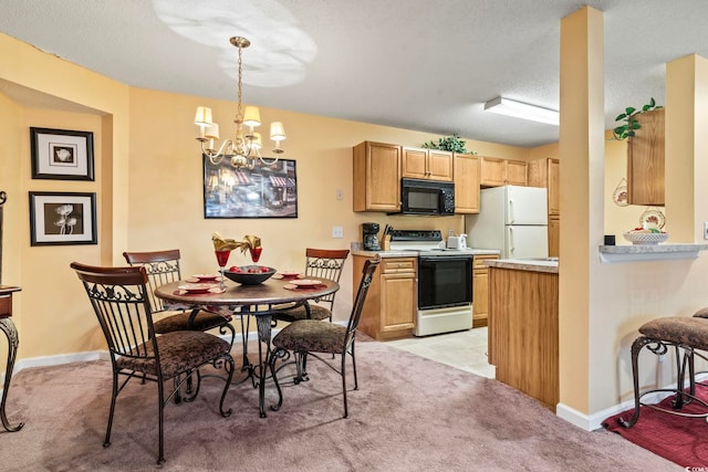 2276 Essex Dr Unit H, Surfside Beach, SC 29575 - kitchen with electric range, black microwave, freestanding refrigerator, a chandelier, and light countertops