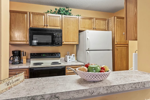 2276 Essex Dr Unit H, Surfside Beach, SC 29575 - kitchen featuring black microwave, electric stove, freestanding refrigerator, light countertops, and a textured ceiling