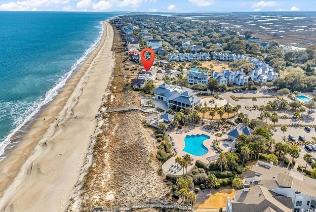 aerial view featuring a beach view, a water view, and a residential view