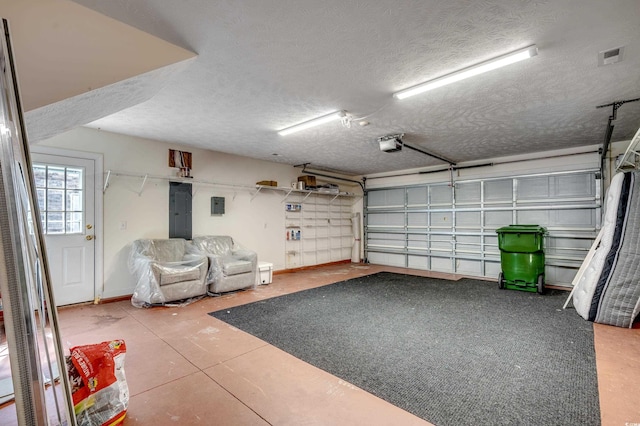 garage featuring electric panel and a garage door opener