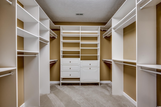 spacious closet featuring light carpet and visible vents