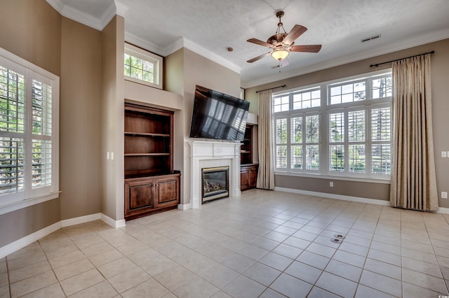 unfurnished living room featuring light tile patterned floors, ornamental molding, a textured ceiling, and built in shelves