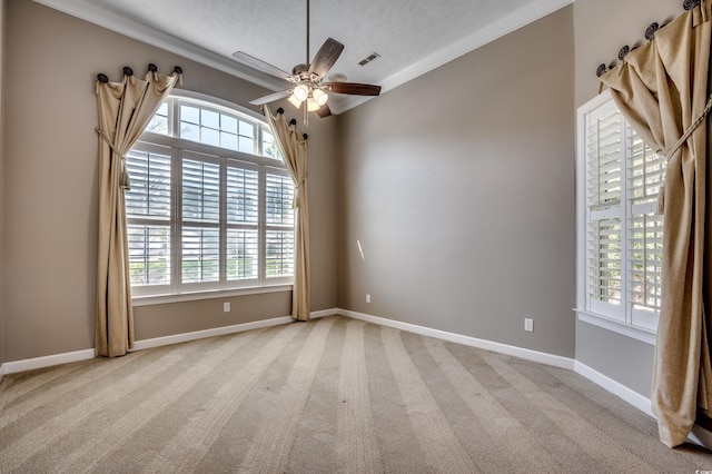 spare room featuring carpet, visible vents, a ceiling fan, a textured ceiling, and baseboards