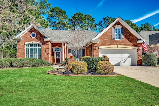 traditional-style home with brick siding, roof with shingles, concrete driveway, a garage, and a front lawn