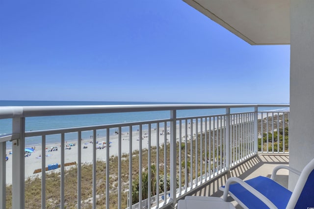 balcony featuring a beach view and a water view