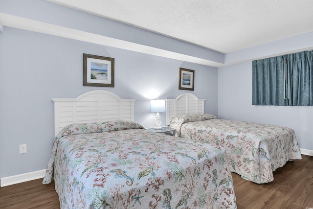 bedroom featuring baseboards and wood finished floors