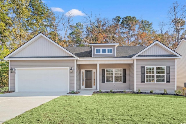 view of front of home featuring an attached garage, driveway, a shingled roof, and a front yard