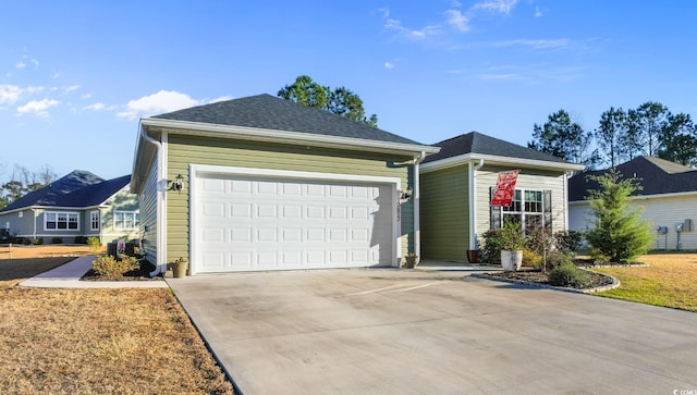 single story home featuring driveway, a shingled roof, and a garage